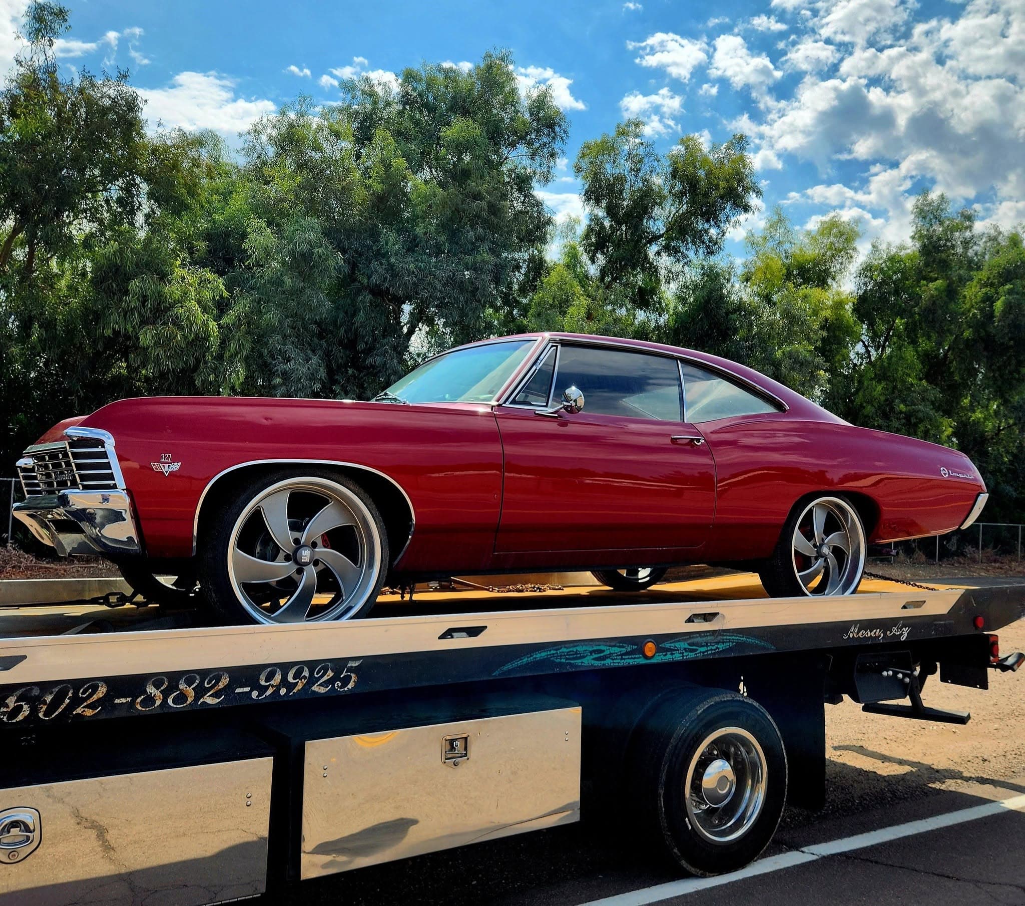 F&S Towing flatbed hauling a classic red 1967 Chevrolet Impala