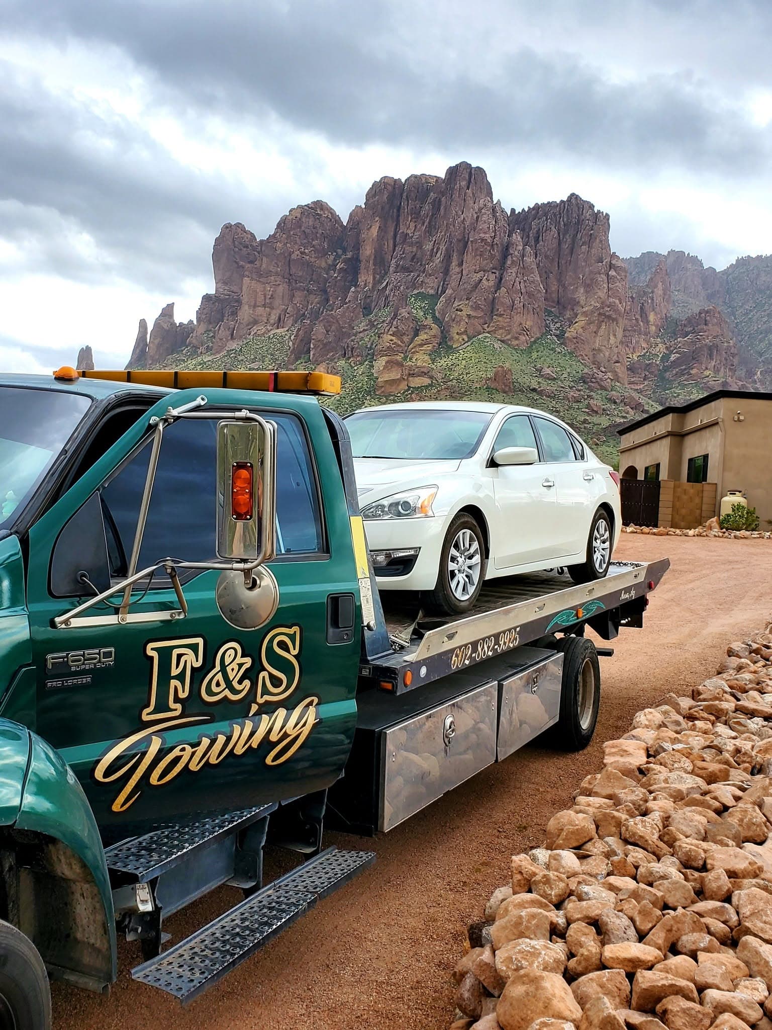 F&S Towing flatbed hauling a vehicle in the Arizona desert