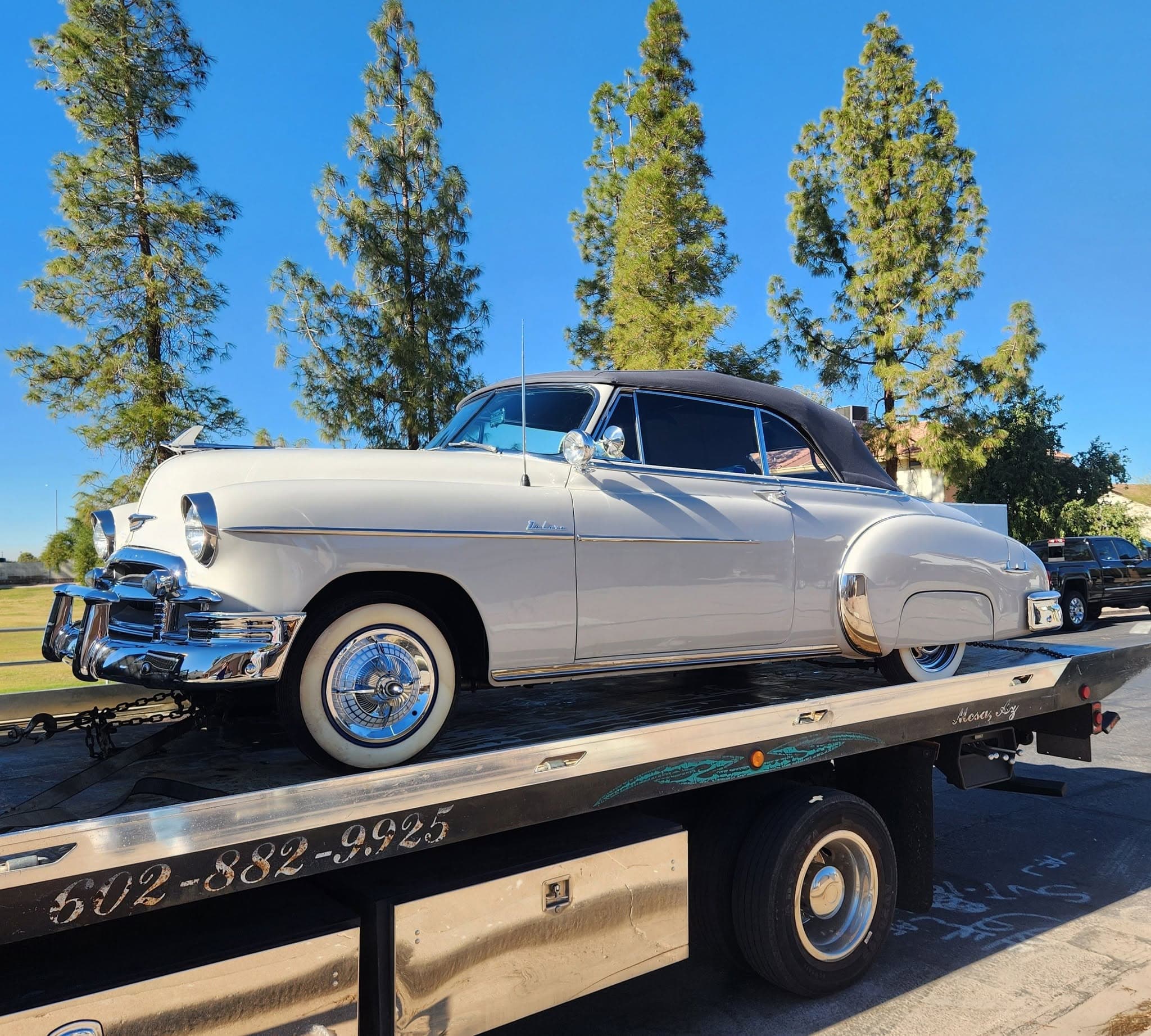 F&S Towing flatbed hauling a cream 1950s Chevrolet Deluxe convertible